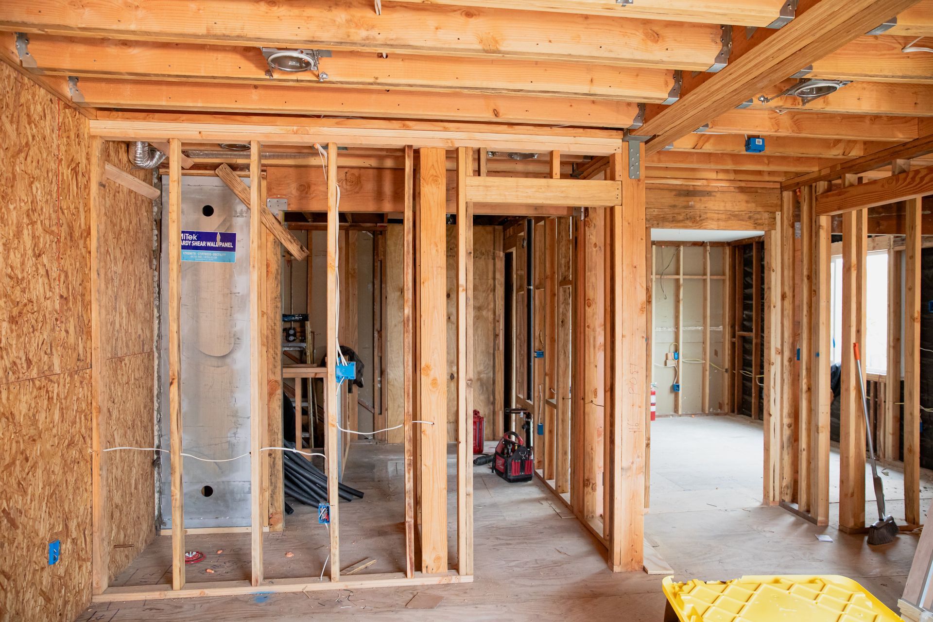 A room in a house under construction with wooden beams.