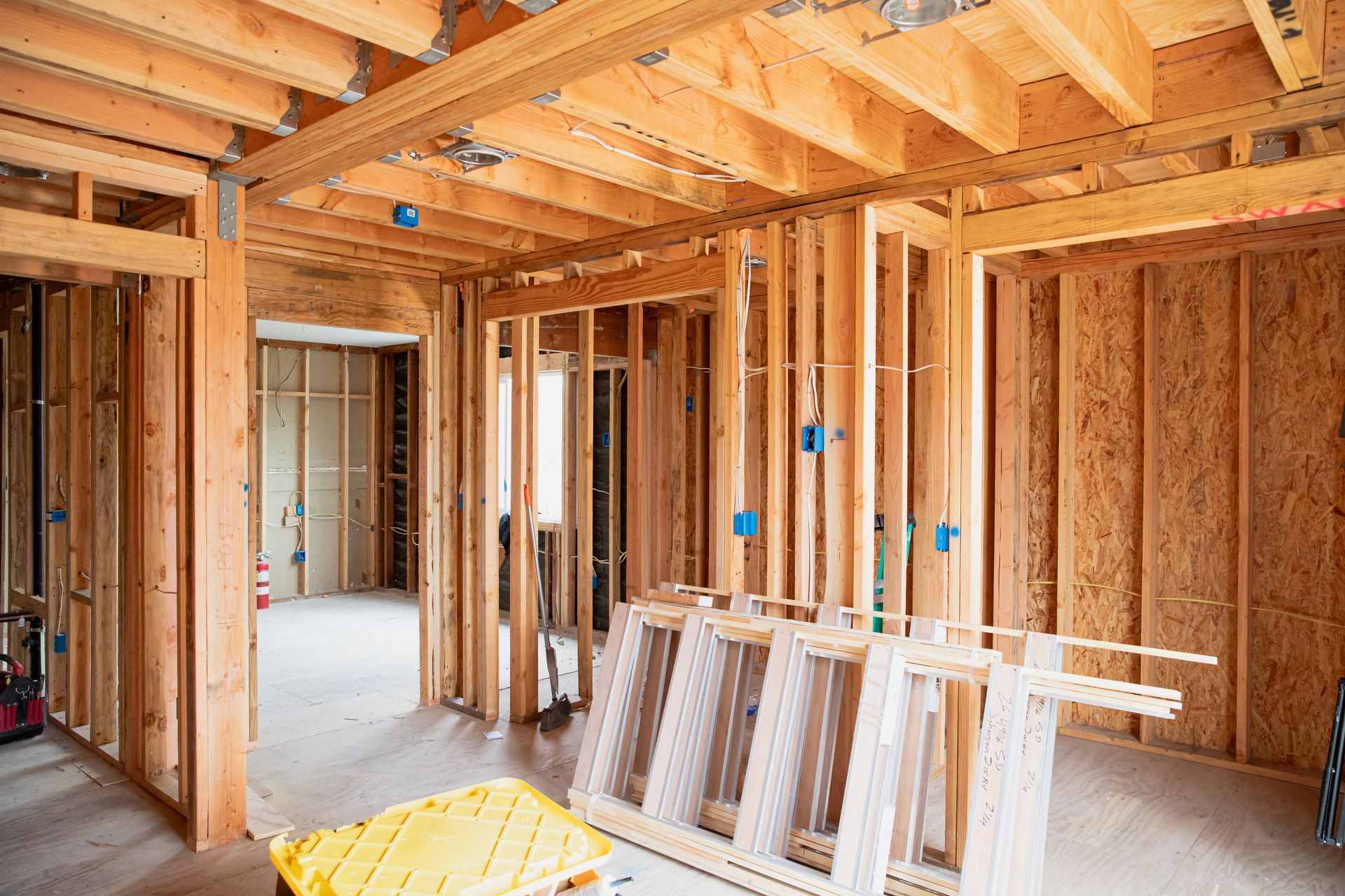 A room in a house under construction with a ladder on the floor.