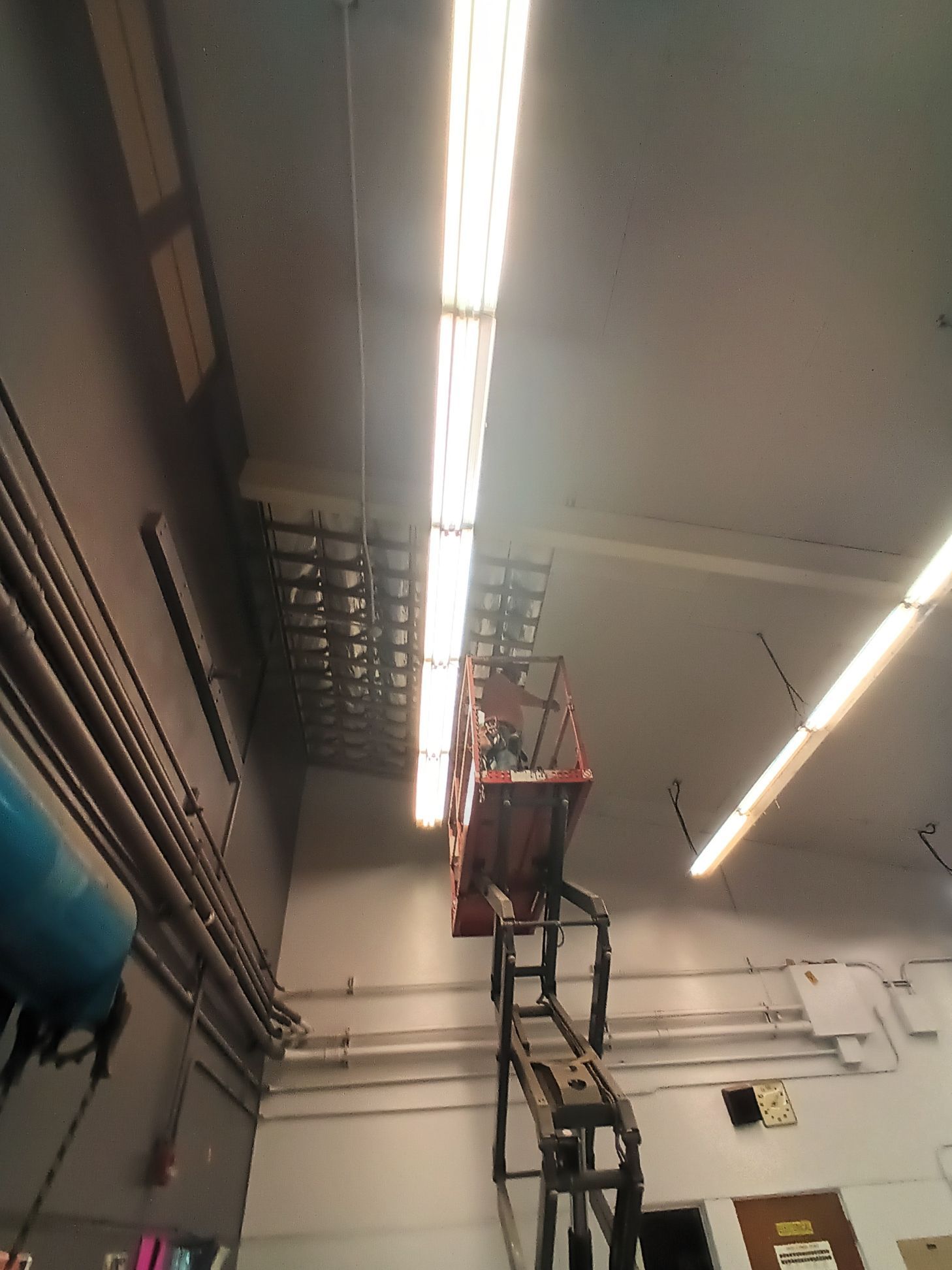A ladder is being used to reach the ceiling of a building
