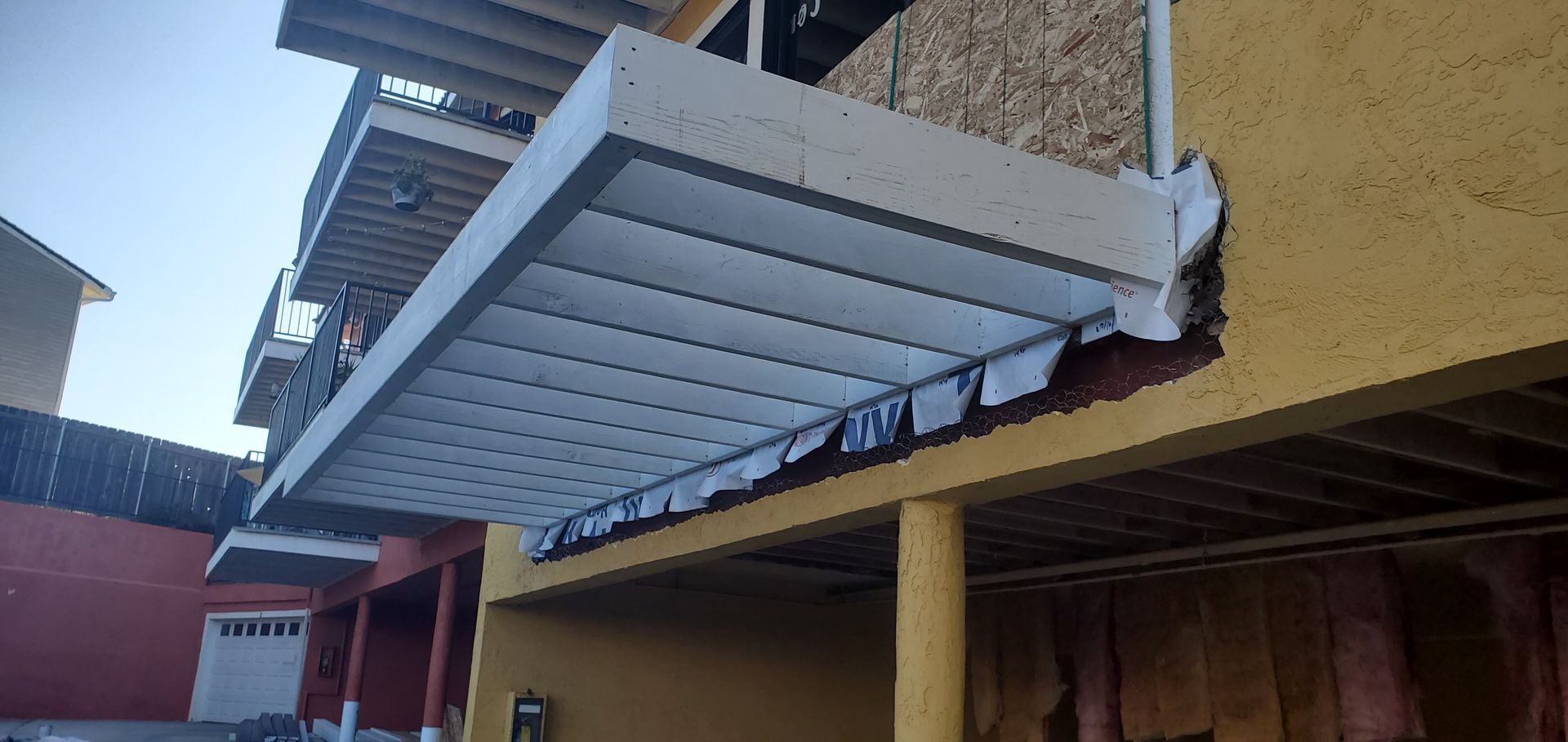A yellow building with a white awning on top of it