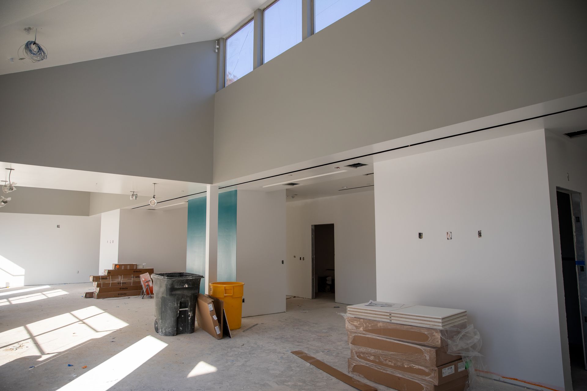 A large room with a lot of windows and boxes on the floor