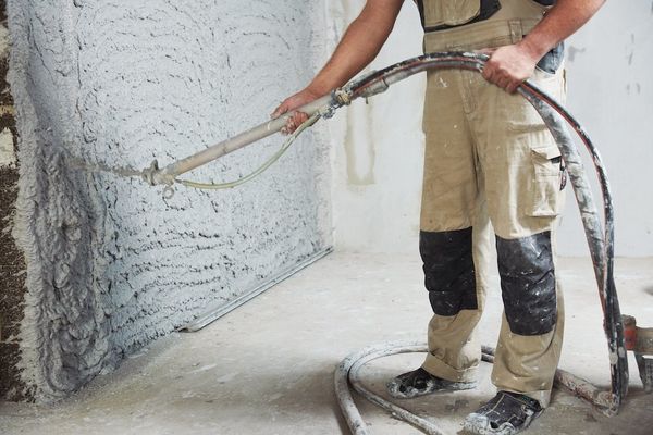 plaster worker with hose
