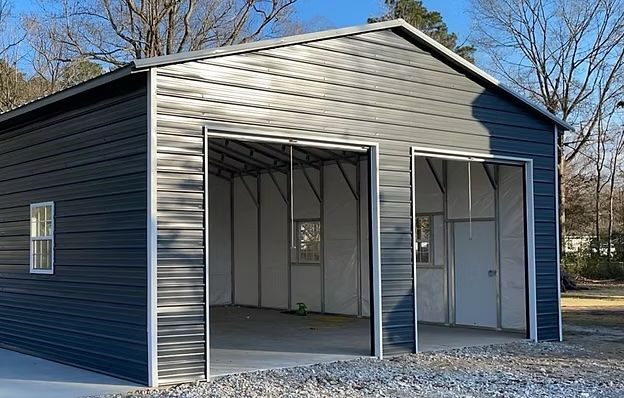 Two-bay metal garage with dark gray siding and open doors.