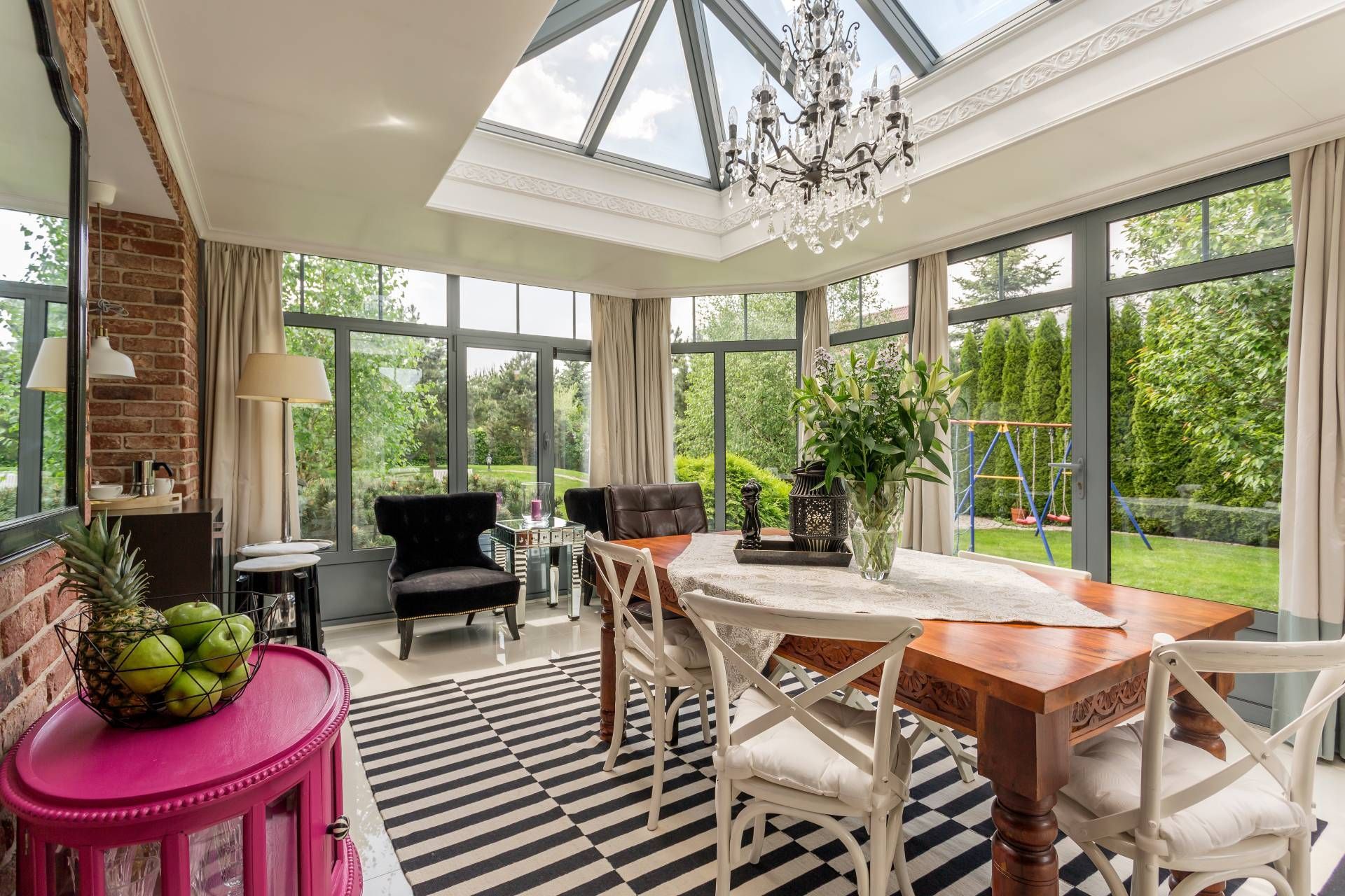 Sunroom with dining table and chairs, accent seats, decor, and window treatments near Frederick, MD