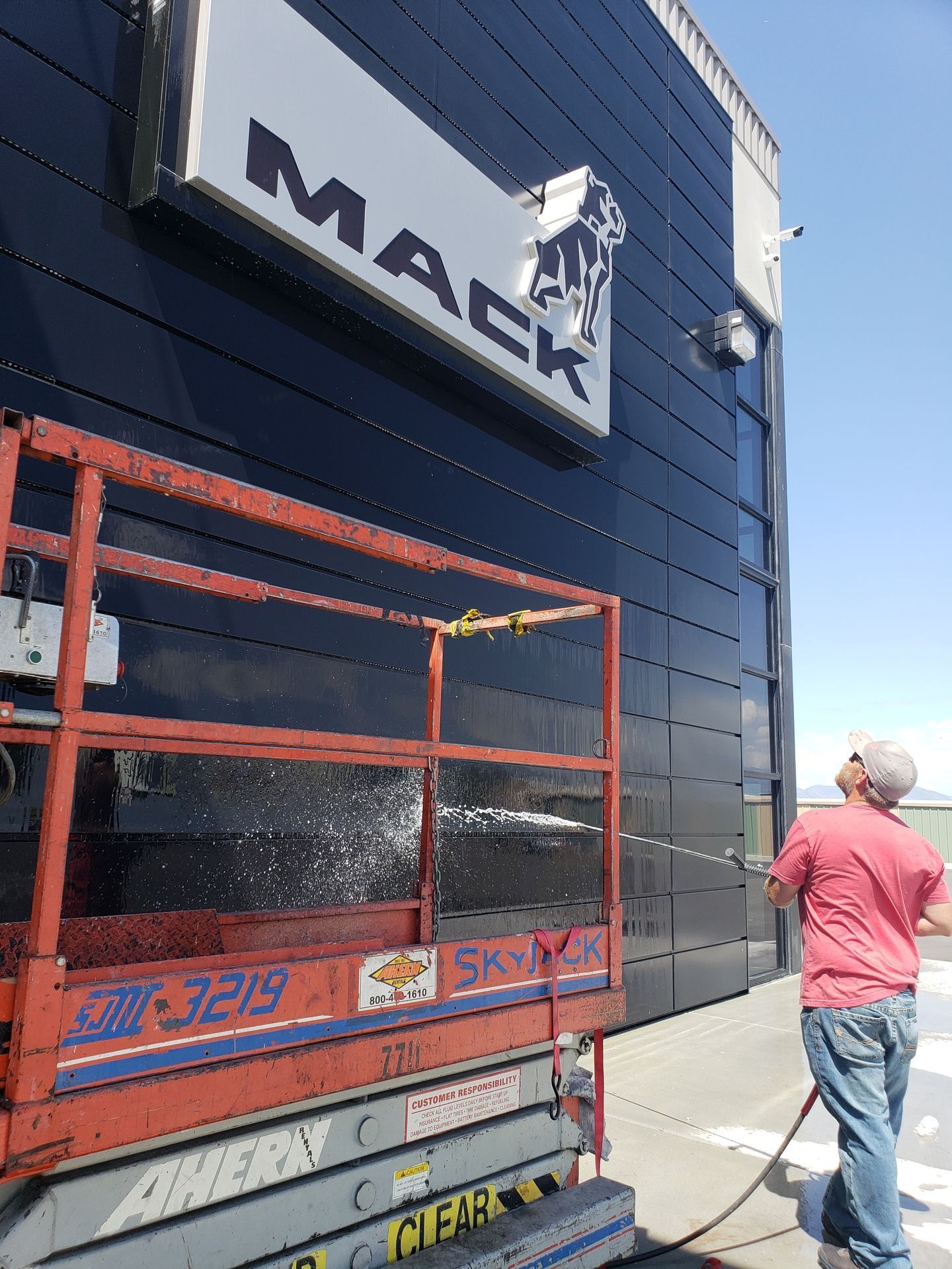 High-reach soft pressure washing service for commercial building exterior restoration
