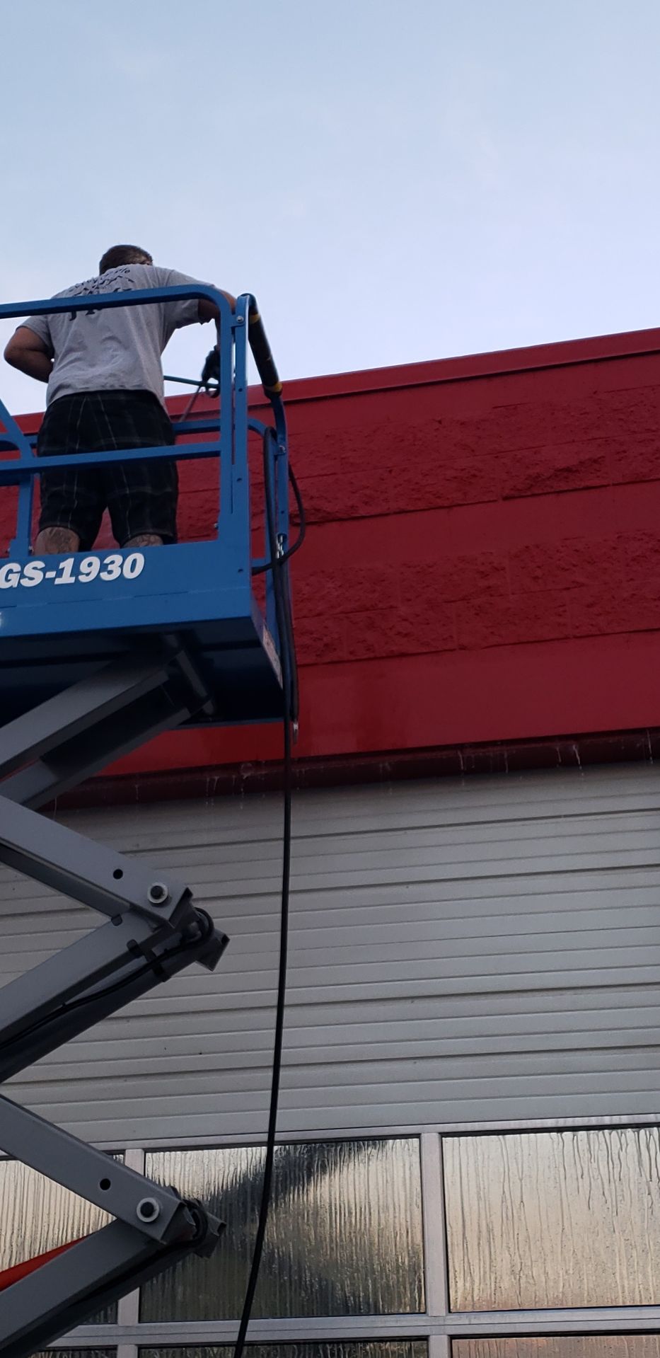 Soft pressure washing service cleaning commercial building exterior walls safely and effectively