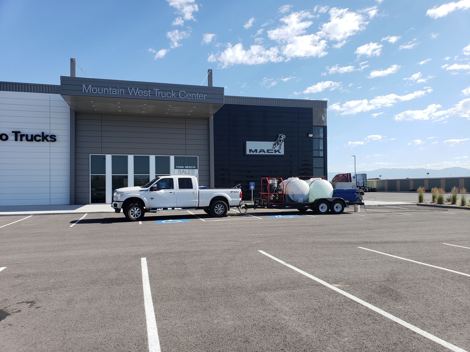 Mobile setup for bulk junk removal and commercial pressure washing services at retail location