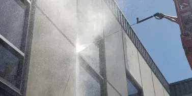 Soft pressure washing services restoring exterior surfaces with commercial-grade equipment