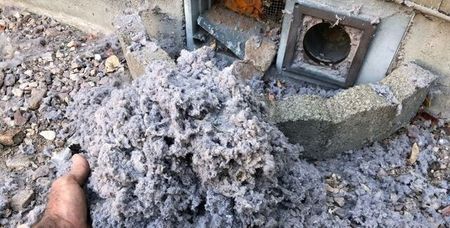 Lint buildup removed by dryer vent cleaning company to prevent fire hazards and airflow blockages