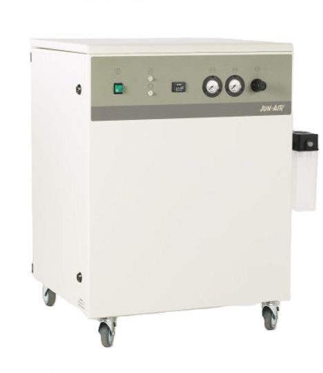 A white Jun-Air compressor with wheels and a green button on it