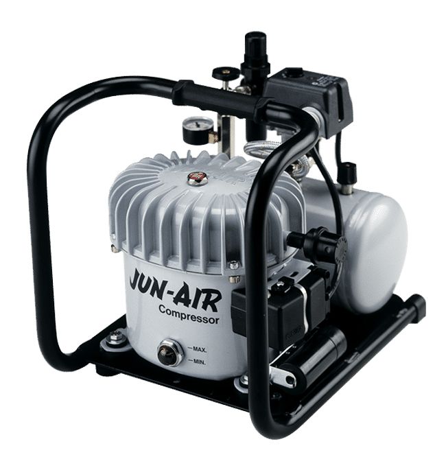 A blue air compressor is sitting on a white surface.