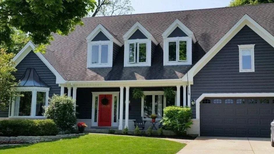 Freshly painted suburban home with crisp blue-gray exterior and white trim