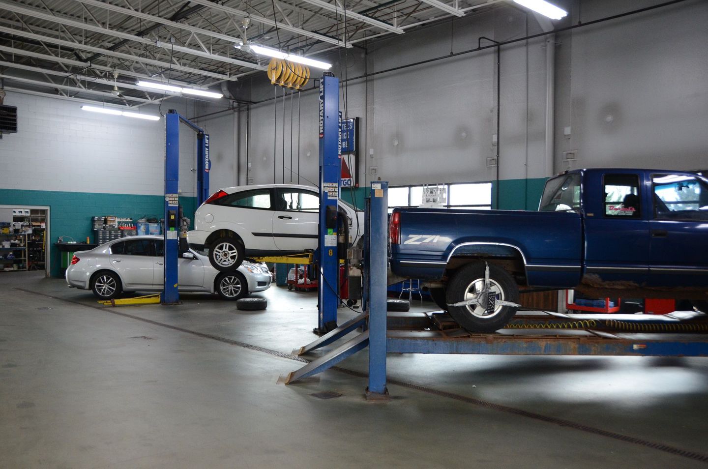 Vehicle Lifted Inside Auto Repair Shop | Bartel's Auto Clinic