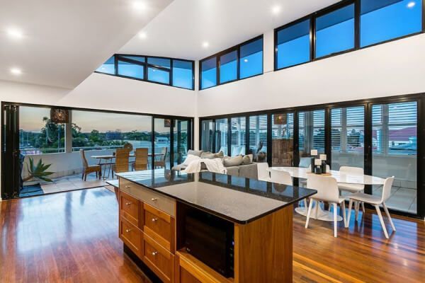 Luxury Byron Bay penthouse apartment with ocean views and modern open-plan living — premium short-term stay accommodation.