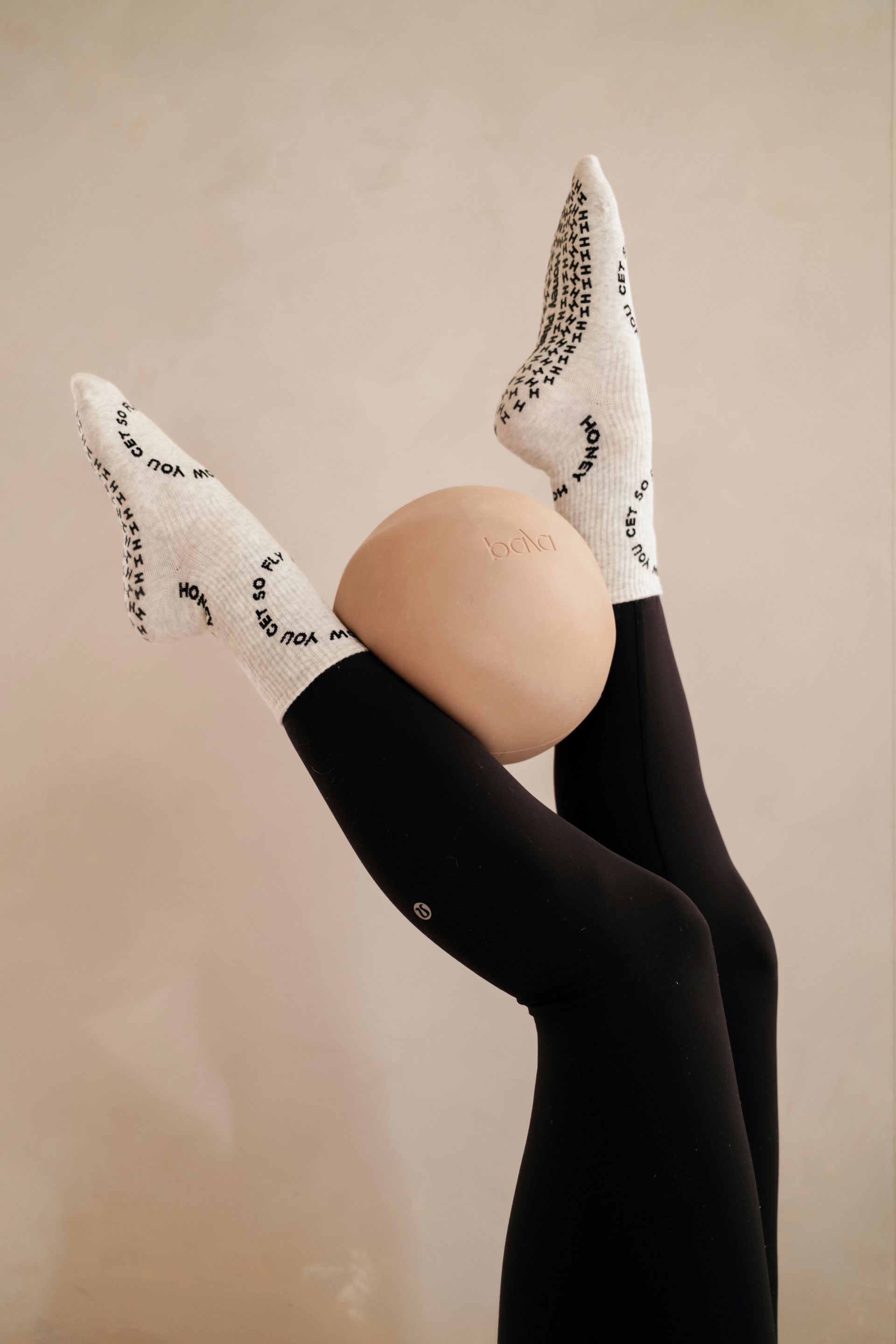 holding a Pilates ball between ankles