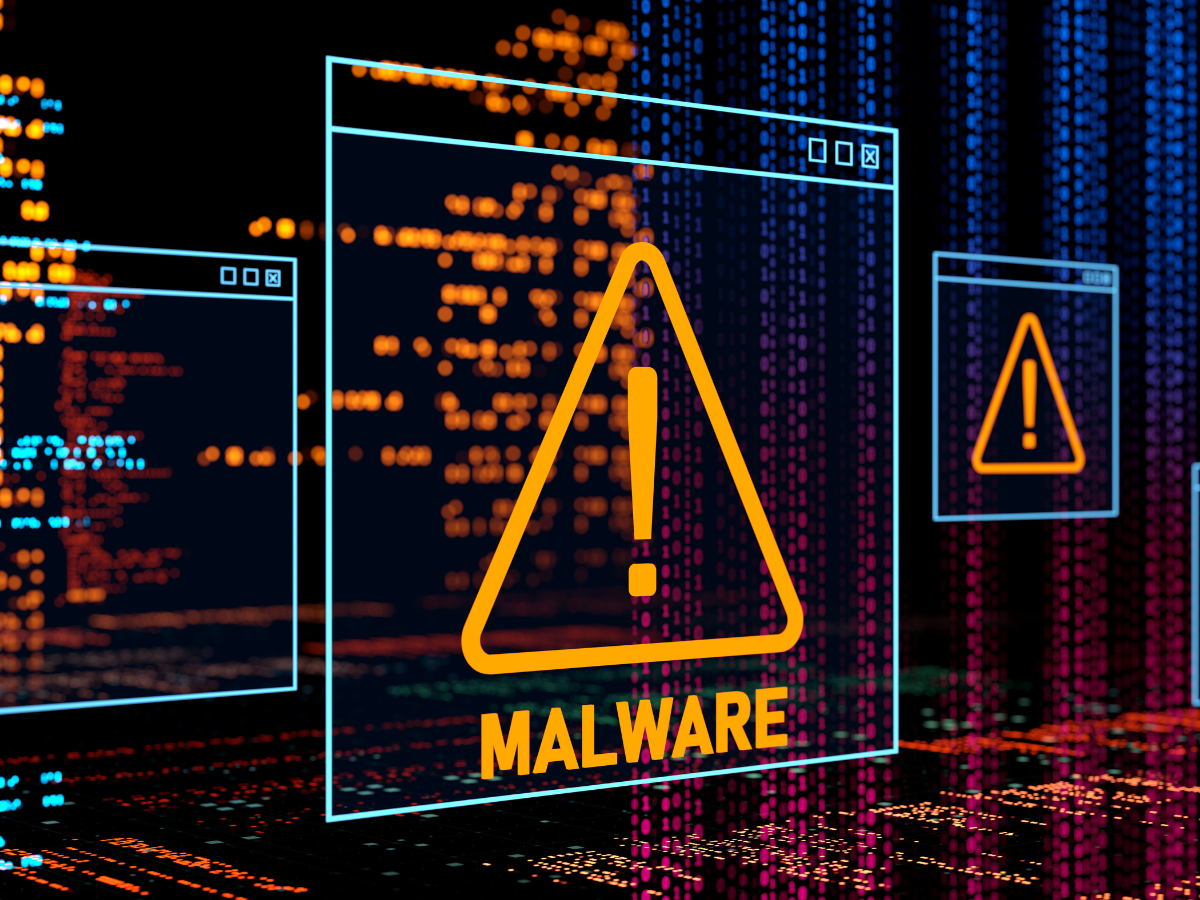 A computer screen with a warning sign and the word malware on it A computer screen with a warning sign and the word malware on it