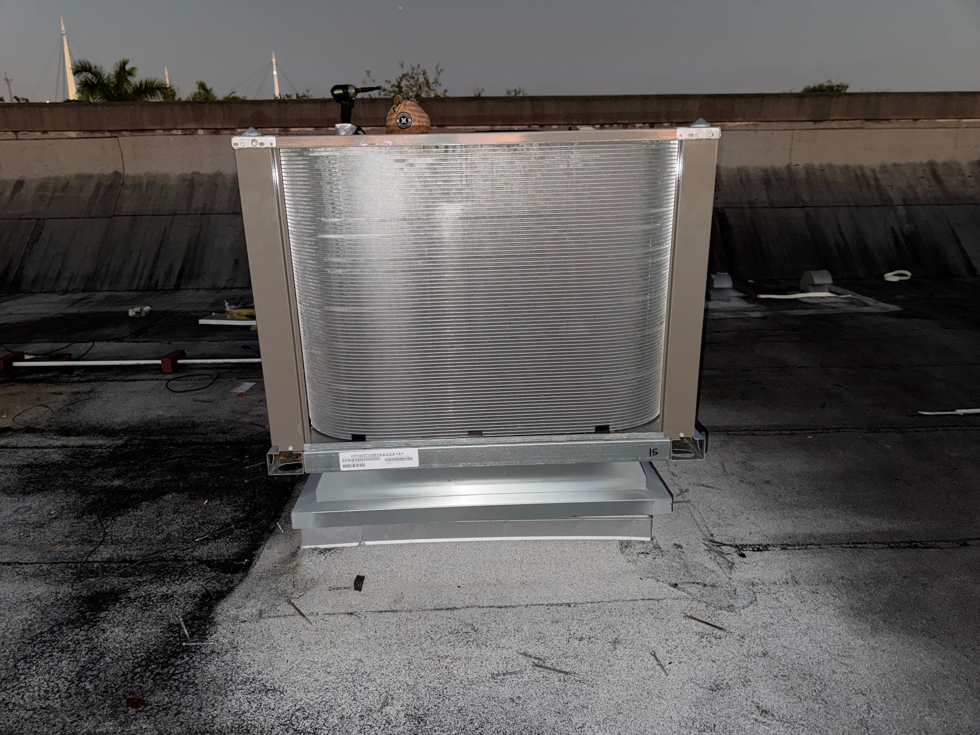Silver rooftop HVAC unit on a flat roof under a clear sky