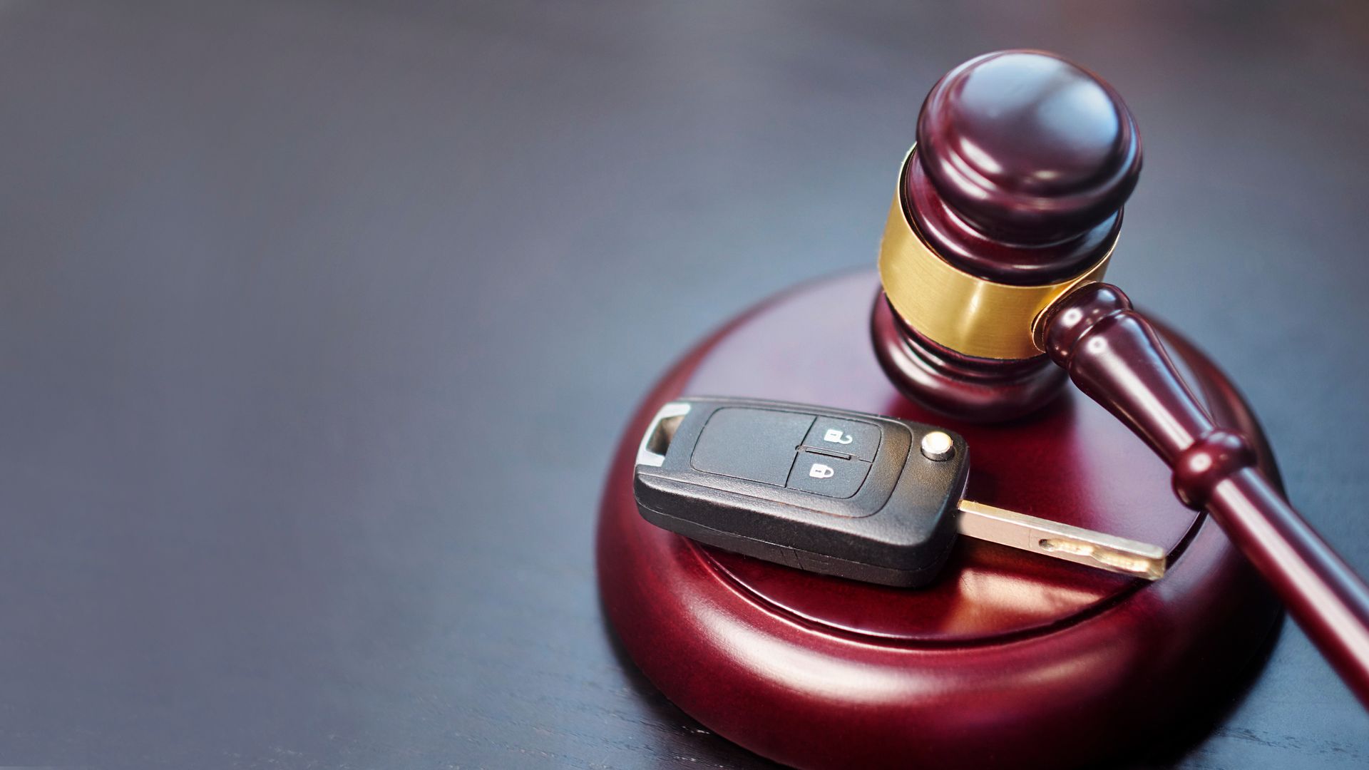 Driver license revocation concept next to the judge hammer. Traffic violation concept by car next to