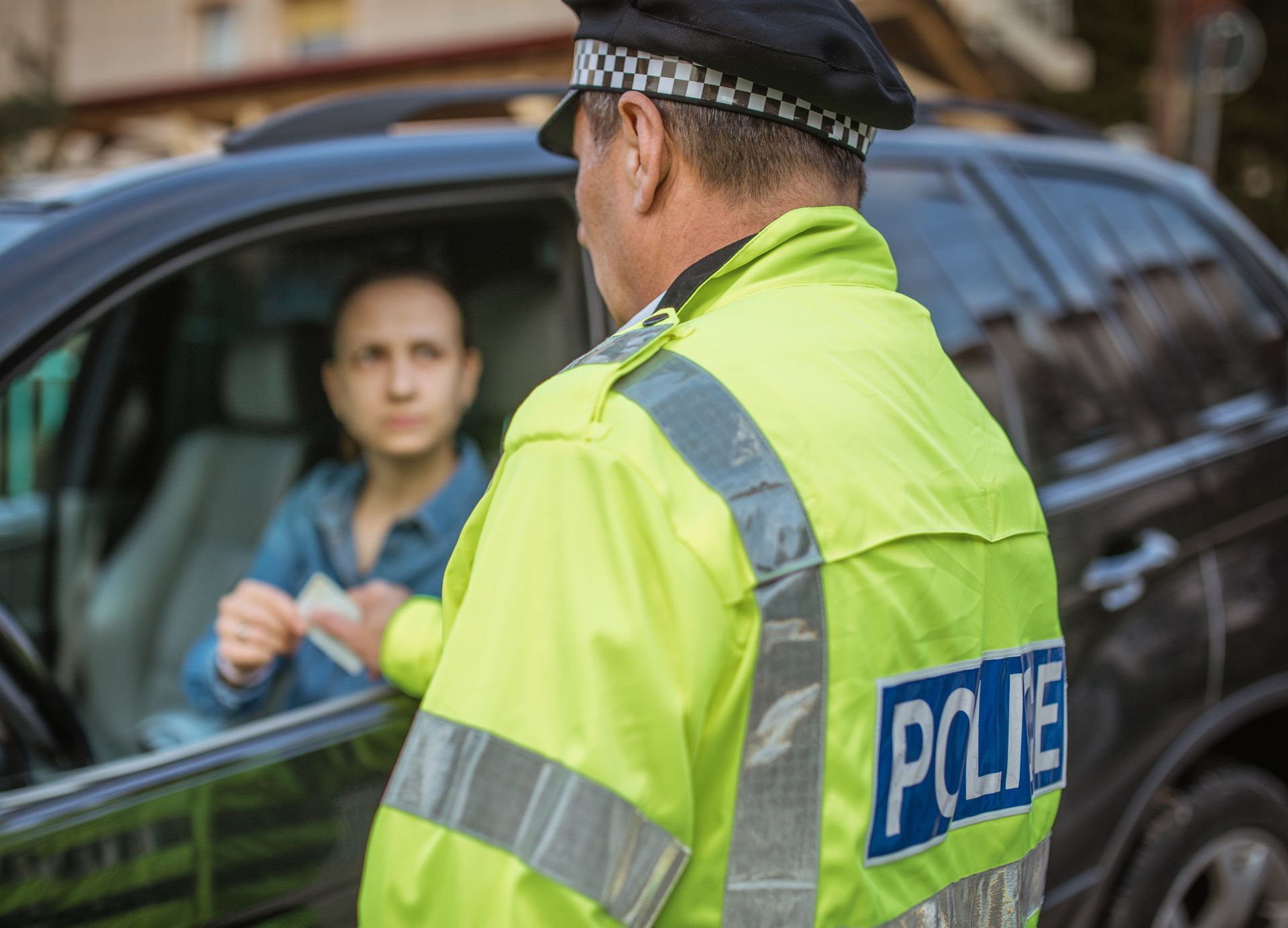 Police man giving a speeding ticket. Police man giving a speeding ticket.