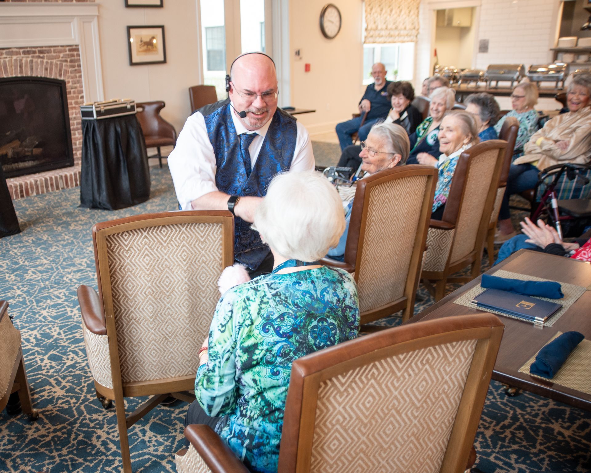 Mike performing for seniors and families in a community room