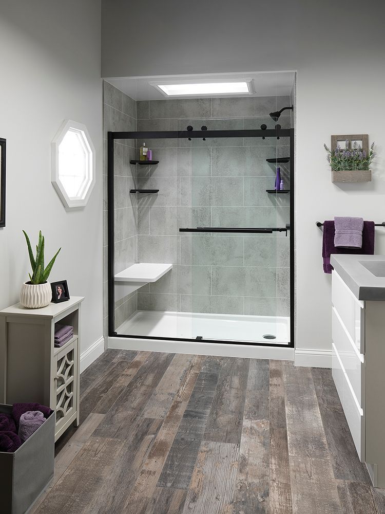 Corner shower stall with black frame and stone-pattern walls in a bathroom