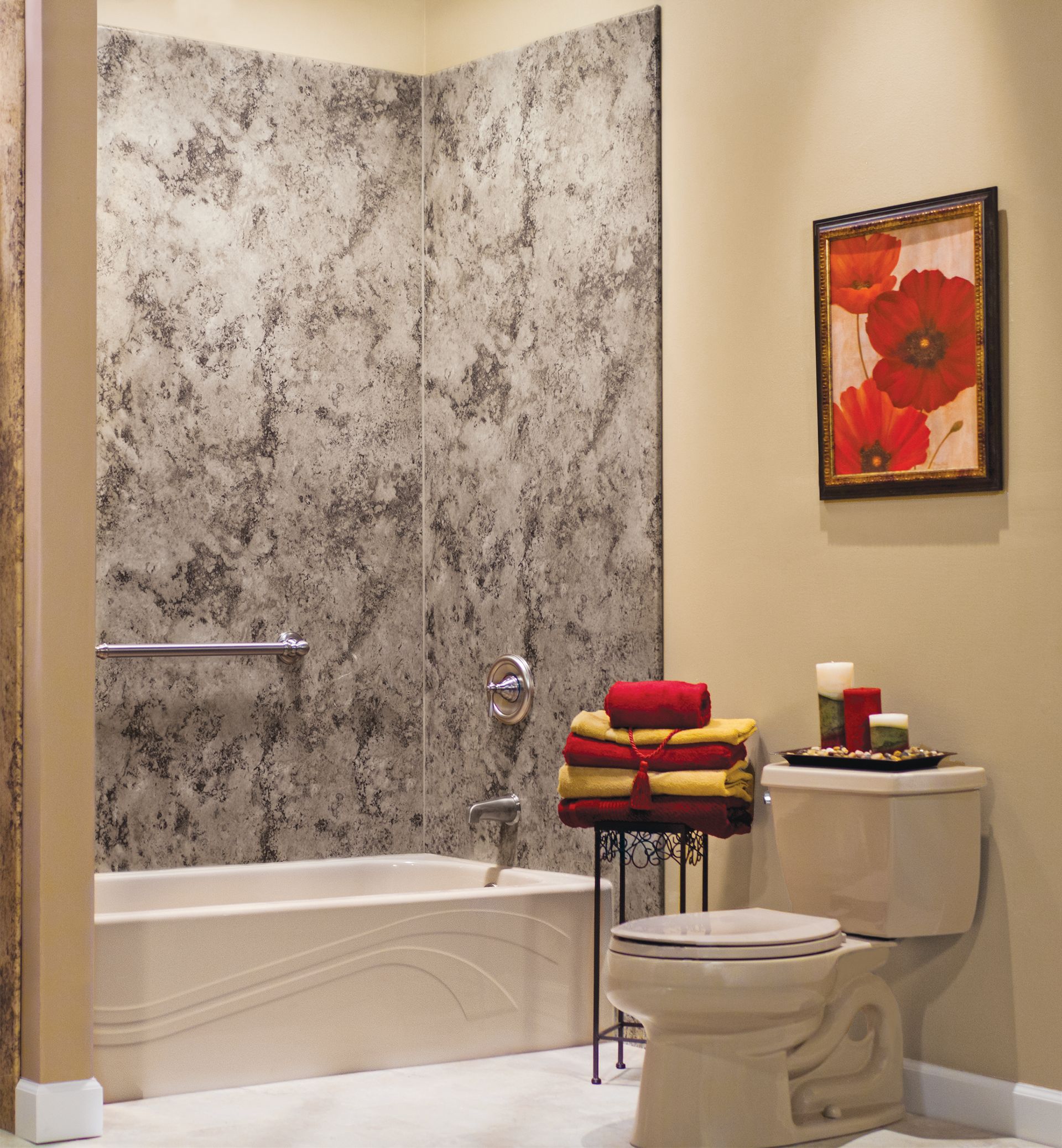 Bathroom with tub, toilet, wall art, and folded towels on a stand