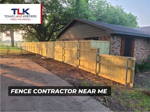 Wooden privacy fence beside a house with “Fence Contractor Near Me” text overlay