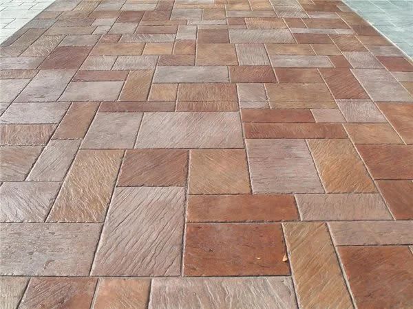 Brick patio pavement with tan, red, and brown rectangular tiles