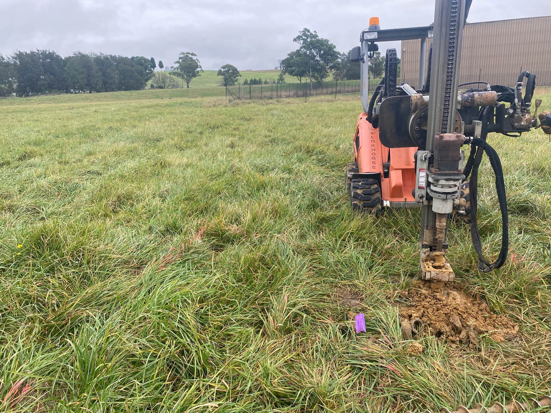 A tractor is sitting in the middle of a grassy field.