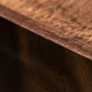 Close-up of a brown textured surface with a sharp diagonal edge and dark shadow beneath