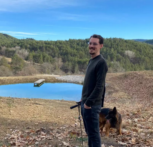 Anatole Franck standing next to a pond