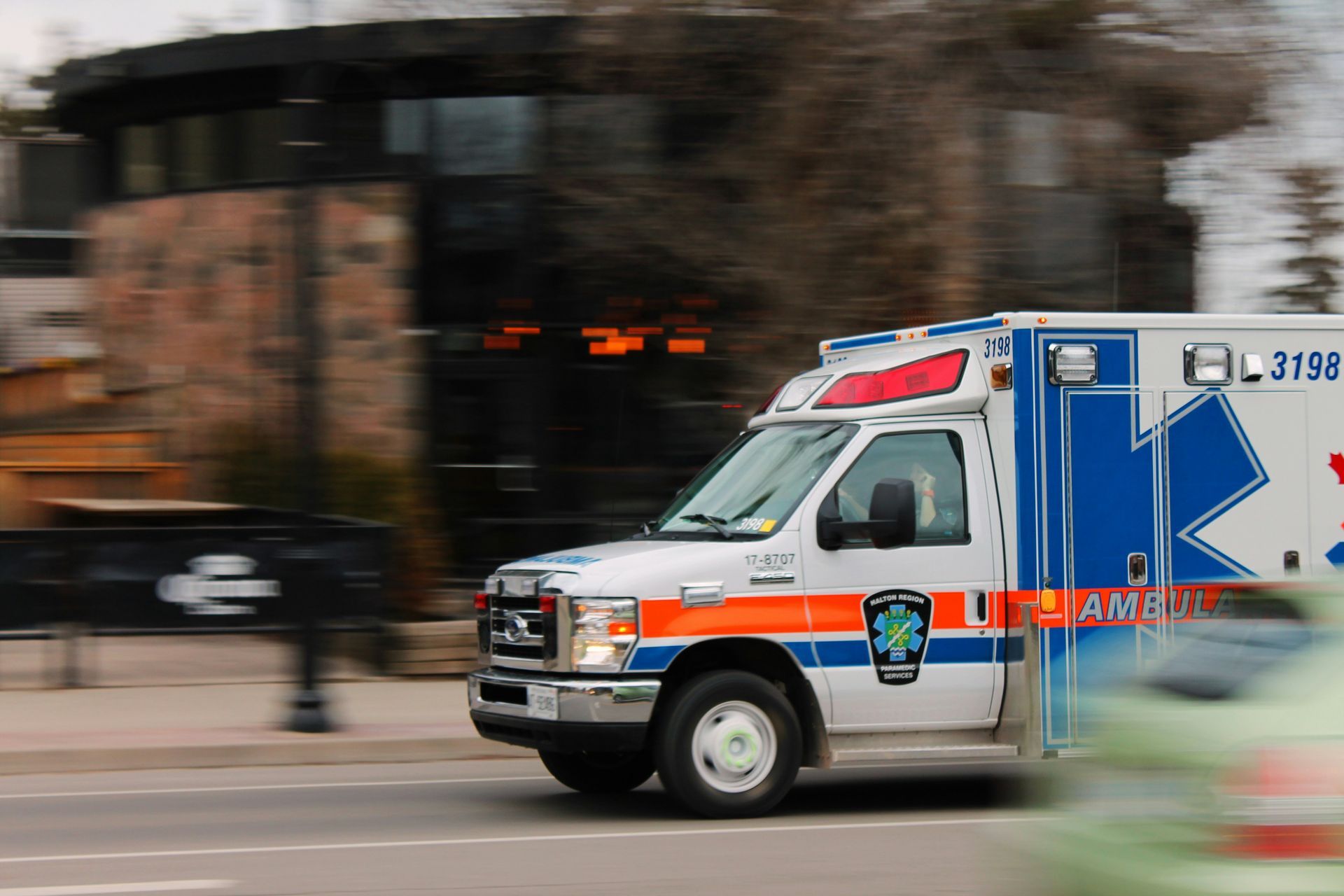 An ambulance is driving down a city street.