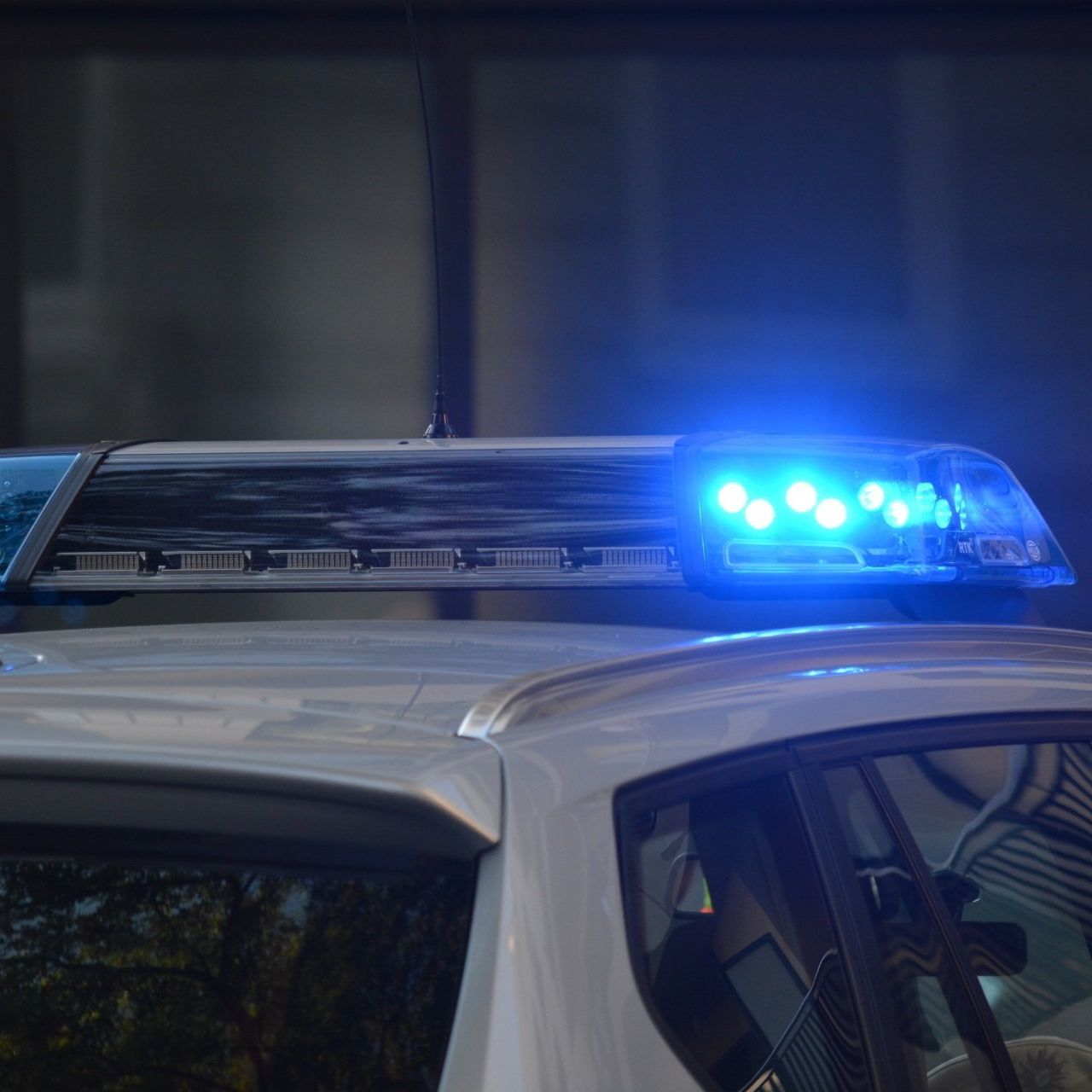 A police car with blue lights on top of it.