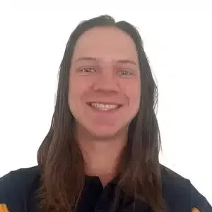 Smiling person with long brown hair against a plain white background