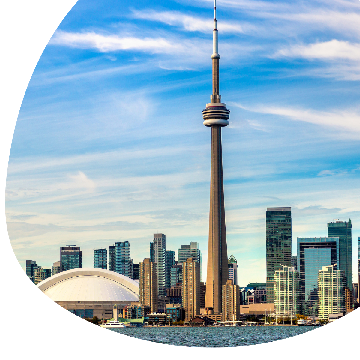 Toronto skyline with CN Tower and Rogers Centre under a blue sky