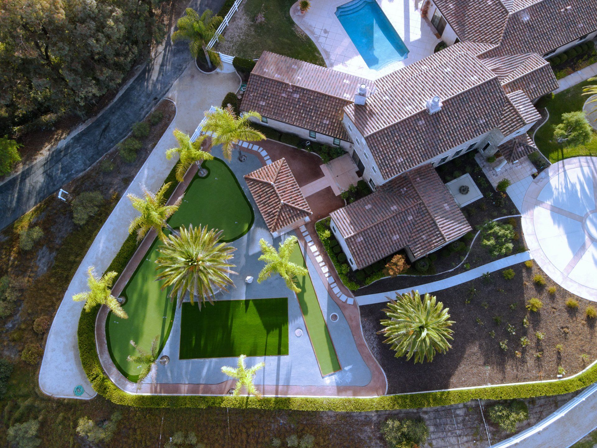 Large yard with artificial grass, decomposed granite, stepping stones