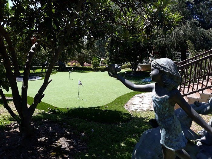 little girl statue and putting green
