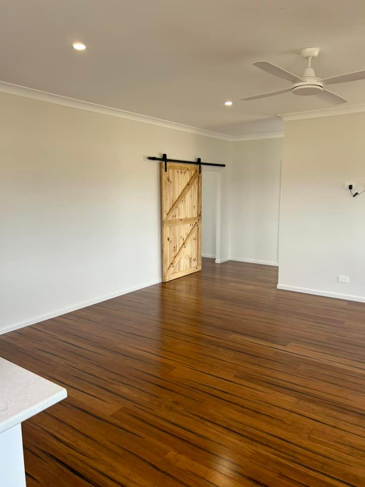 Living Room With A Sliding Door and Ceiling Fan — Builder In Sunshine Coast, QLD