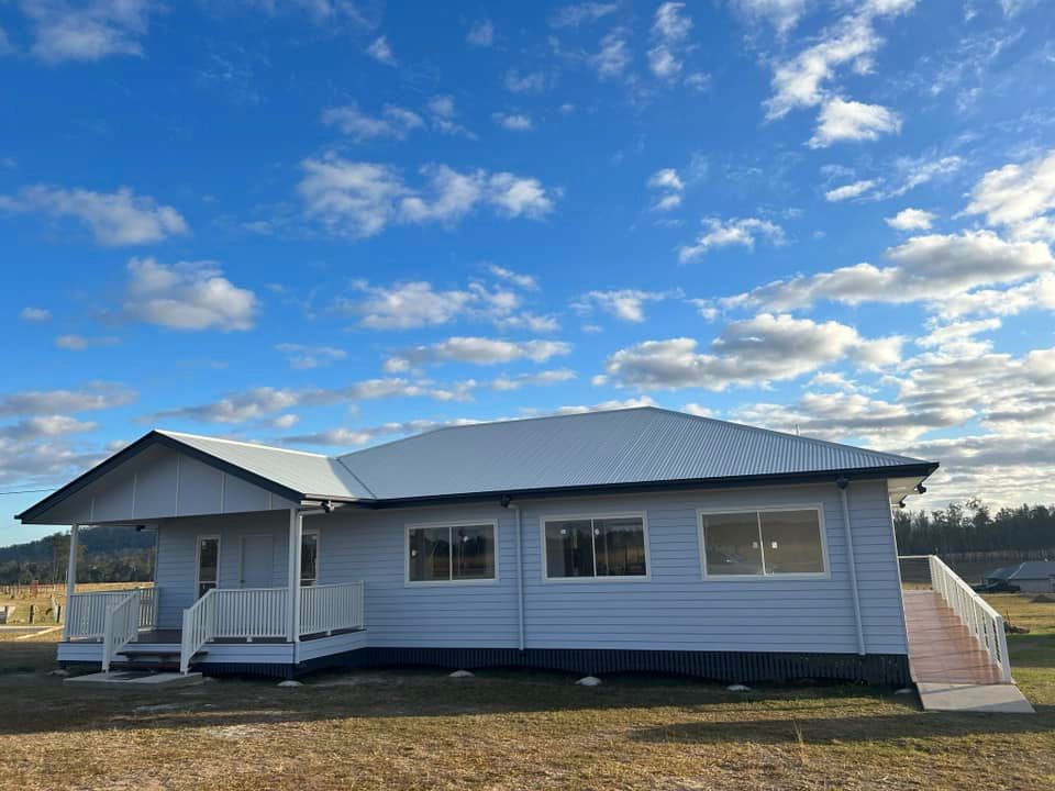 House In Open Area With A Blue Sky In The Background — Builder In Sunshine Coast, QLD