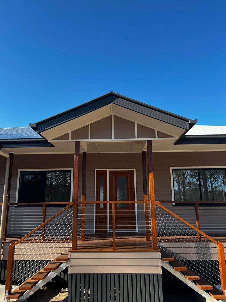 Front Of A House With A Wooden Porch And Stairs — Builder In Gympie, QLD