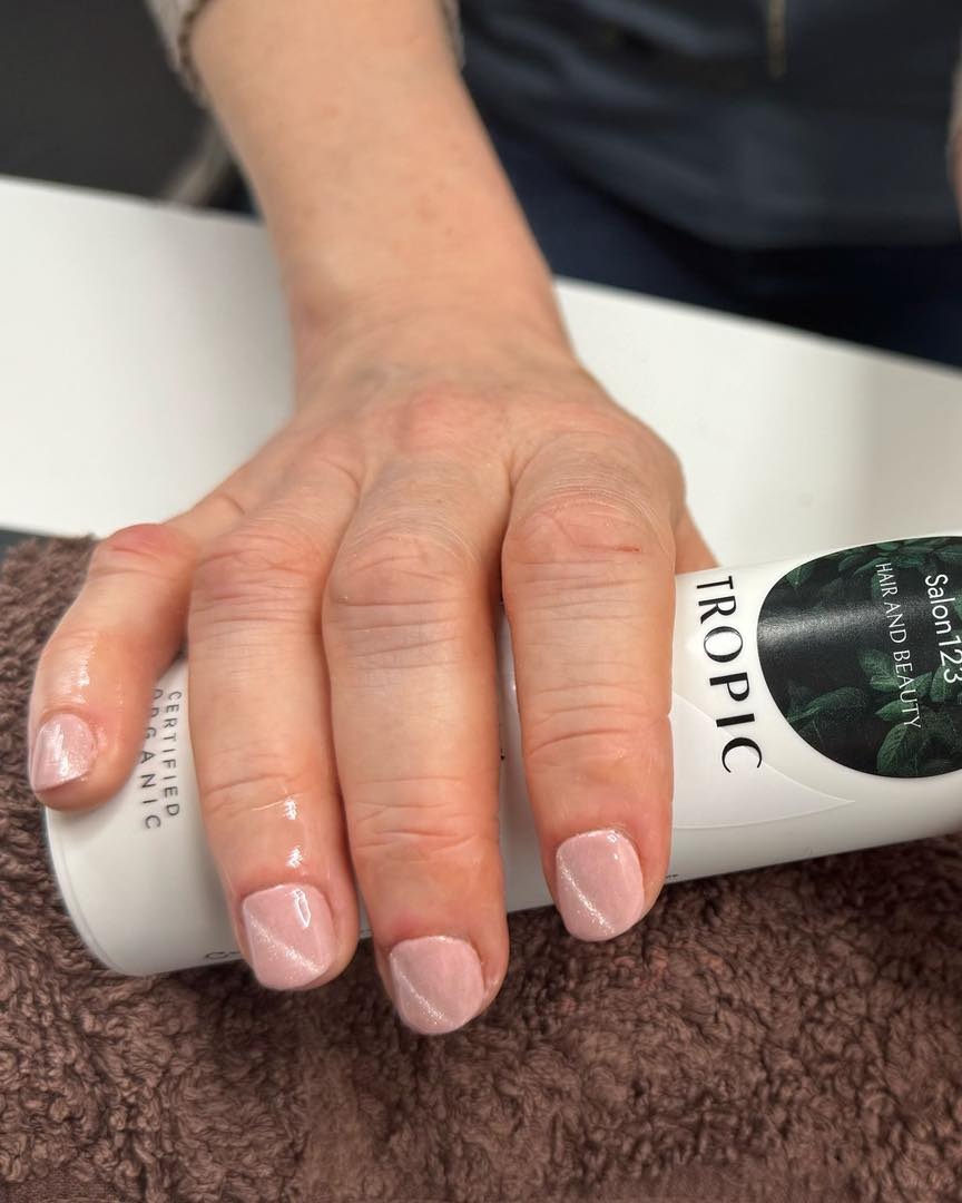A person’s hand with manicured nails