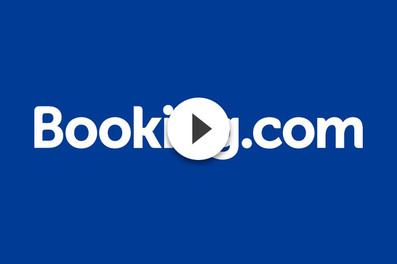 The booking.com logo is on a blue background with a play button.