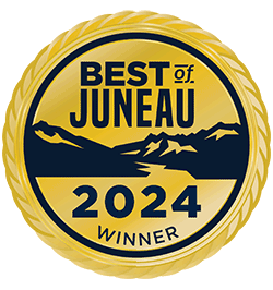 Gold circular “Best of Juneau 2024 Winner” badge with mountain silhouette and blue text
