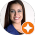 Smiling woman with dark hair in a blue jacket, shown in a circular headshot with an orange star badge.
