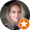 Portrait of a smiling blonde woman with an orange star badge in the corner