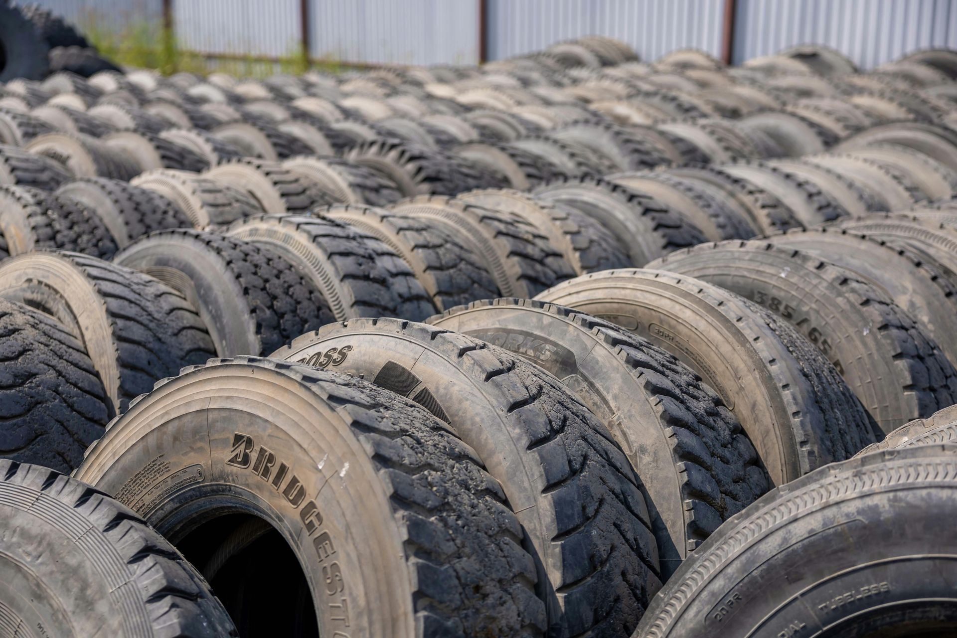 A pile of old tires are stacked on top of each other.