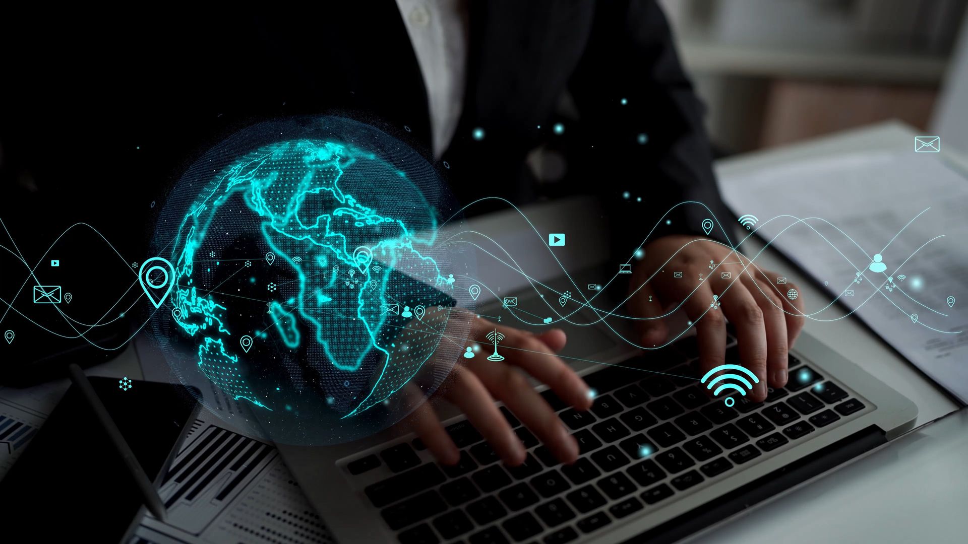 Hands typing on a laptop with a glowing digital globe and network icons overlay.