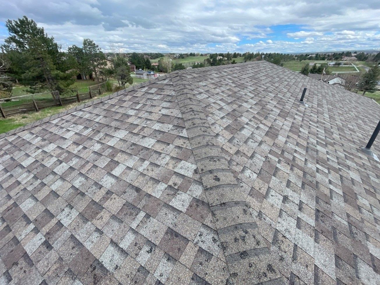 A roof with a lot of hail damaged shingles.
