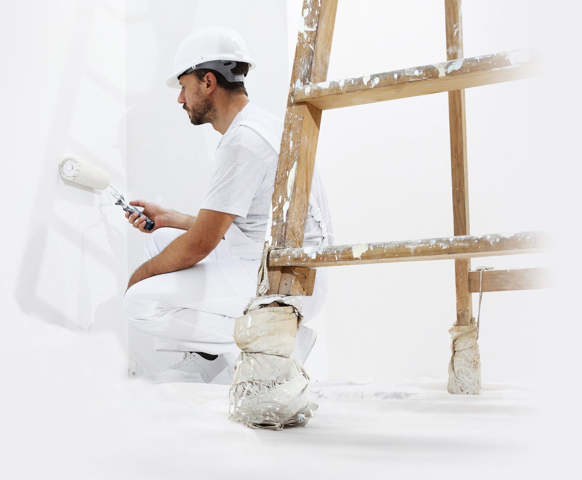 Alpha Pro painter completing detailed wall painting using a ladder and roller