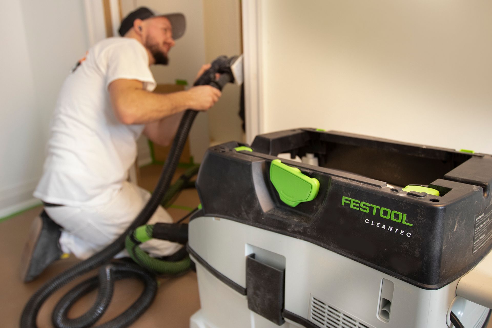 Professional painter sanding interior trim before painting